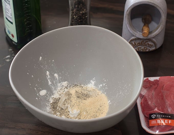 Seasoned flour mixture in gray bowl