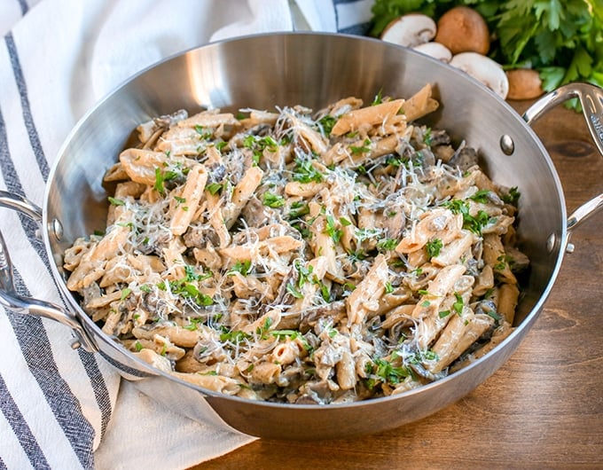 Pot of vegetarian stroganoff topped with Parmesan.