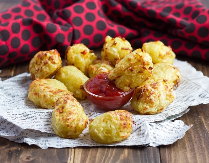 Tater tots with a small dish of ketchup.