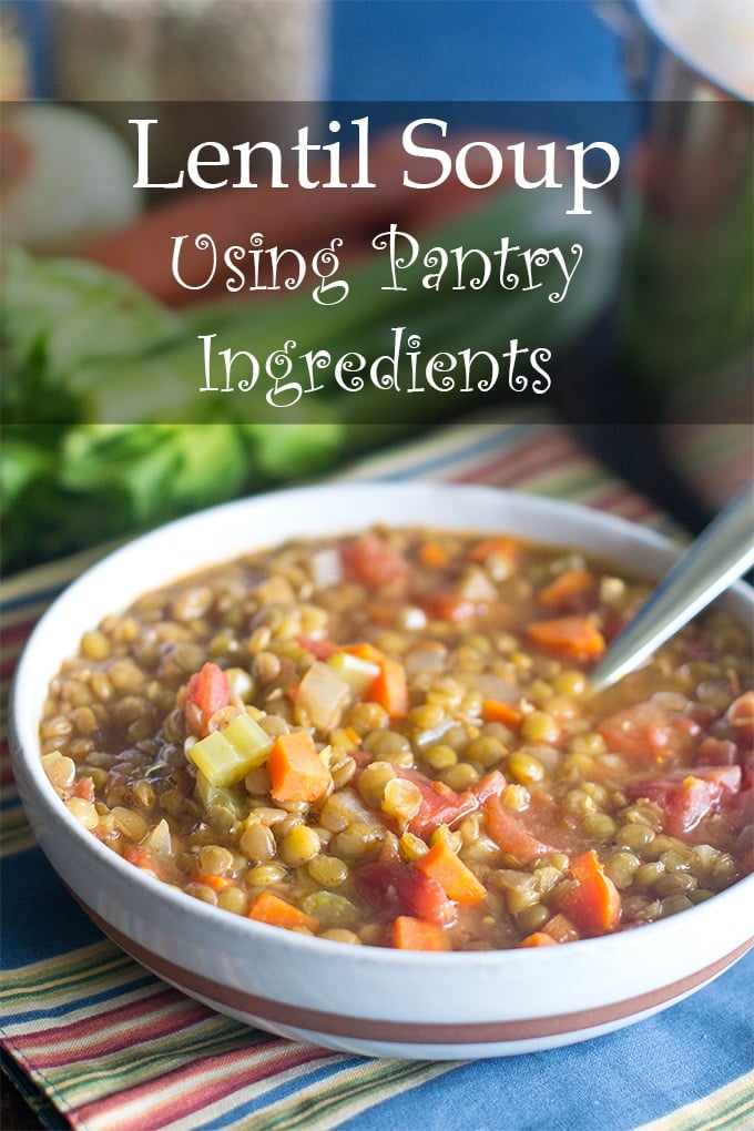 lentil soup with chopped carrots, celery and diced tomatoes in a white bowl with a brown strip on the outside and a silver spoon sticking out of it; the bowl is sitting on a stripped dish towel; the text overlay reads "Lentil Soup Using Pantry Ingredients".