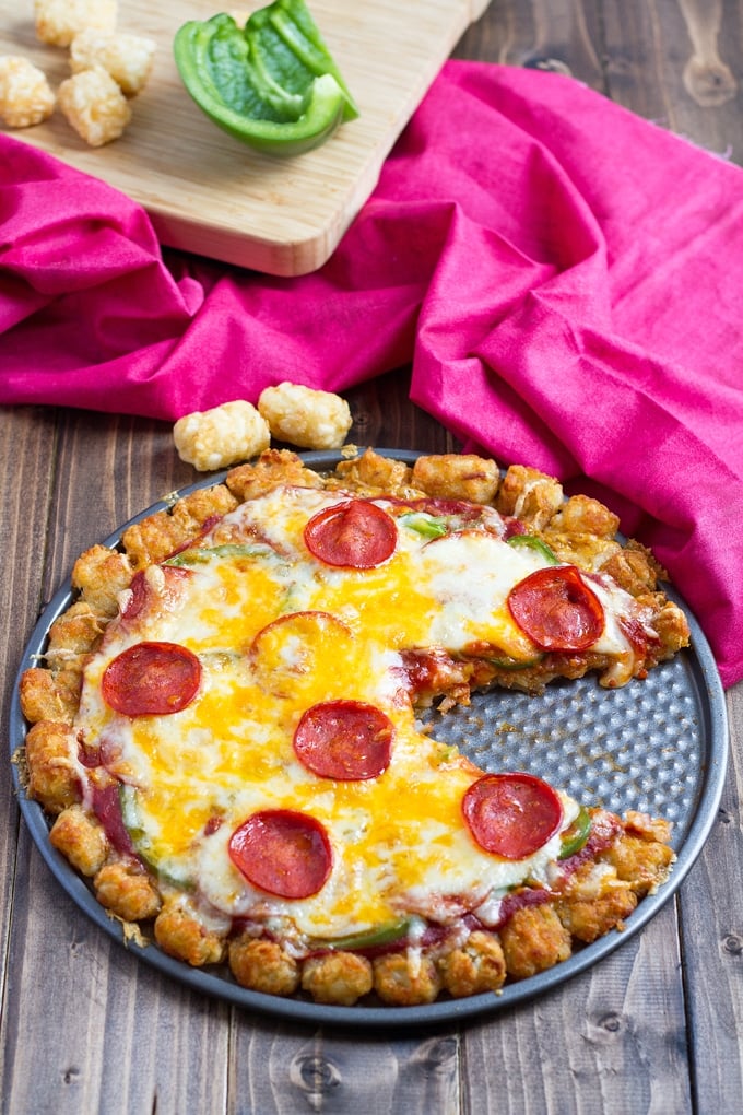 pepperoni pizza with a tater tot crust on a pizza pan.