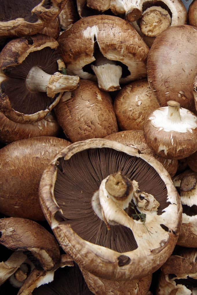 close up of unwashed whole brown mushrooms