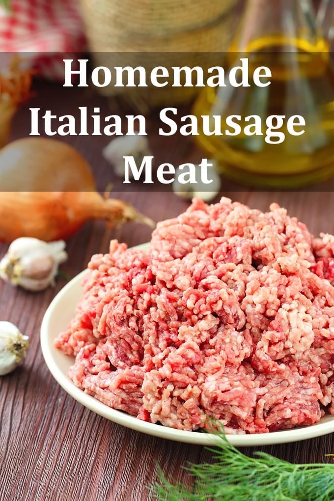 Pile of raw ground meat on a white plate on a wooden table with garlic bulbs and an onion. The text overlay reads, "Homemade Italian Sausage Meat".