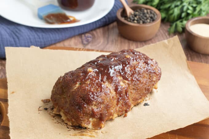 Turkey meatloaf with BBQ sauce on parchment paper.