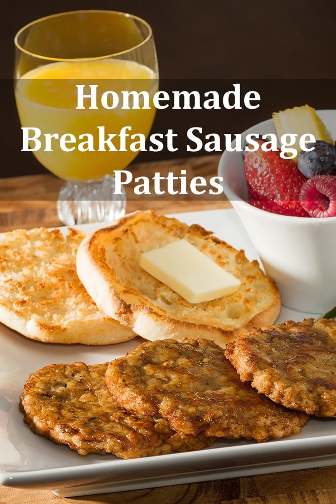 Three breakfast sausage patties cooked and overlapping on a plate. An English muffin with butter is behind it as is a bowl of berries and a glass of juice. The words "Homemade Breakfast Sausage Patties" appear on the image.