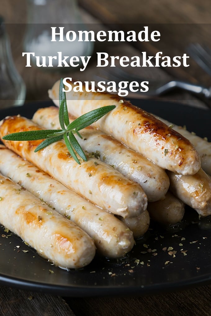 Turkey breakfast sausages in a pile on a black plate. The words "Homemade Turkey Breakfast Sausages" are on the image.