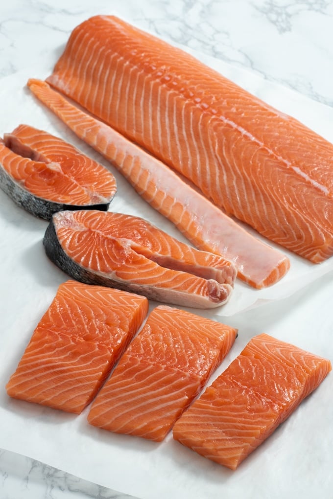 side of salmon, salmon filets, and salmon steaks on paper towel