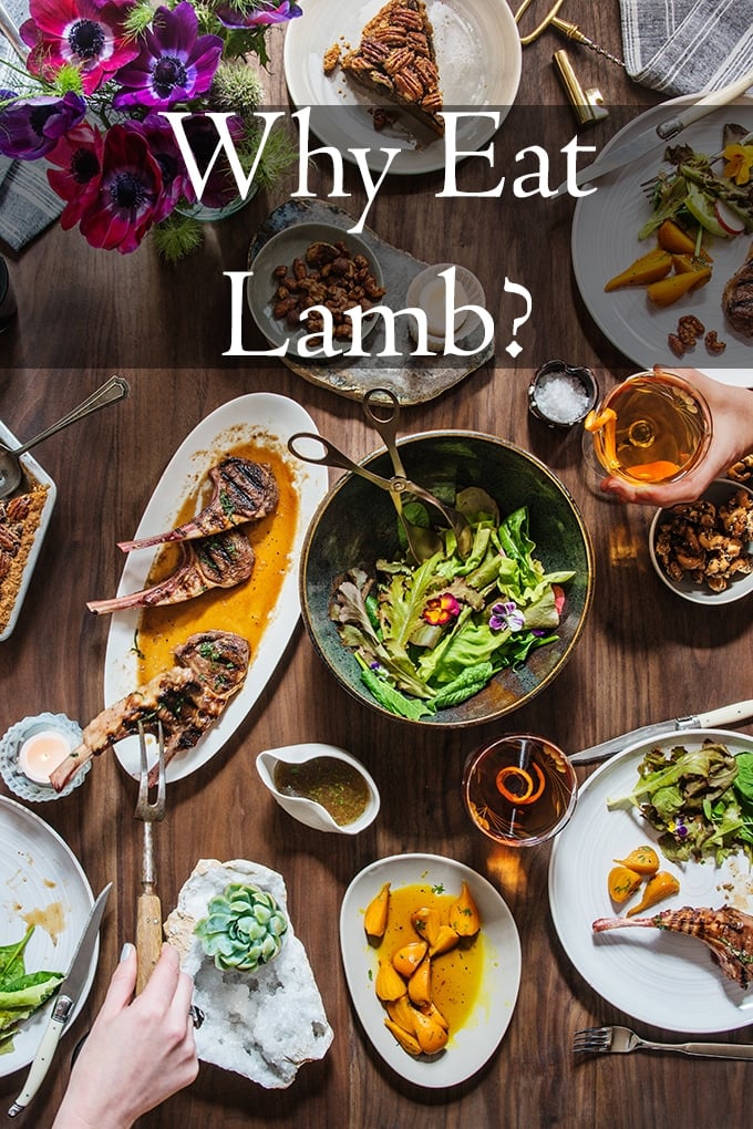 table full of side dishes and lamb chops on platter