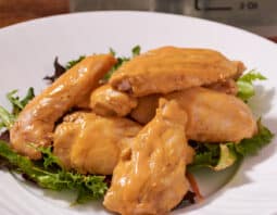 sous vide buffalo wings on plate with greens.