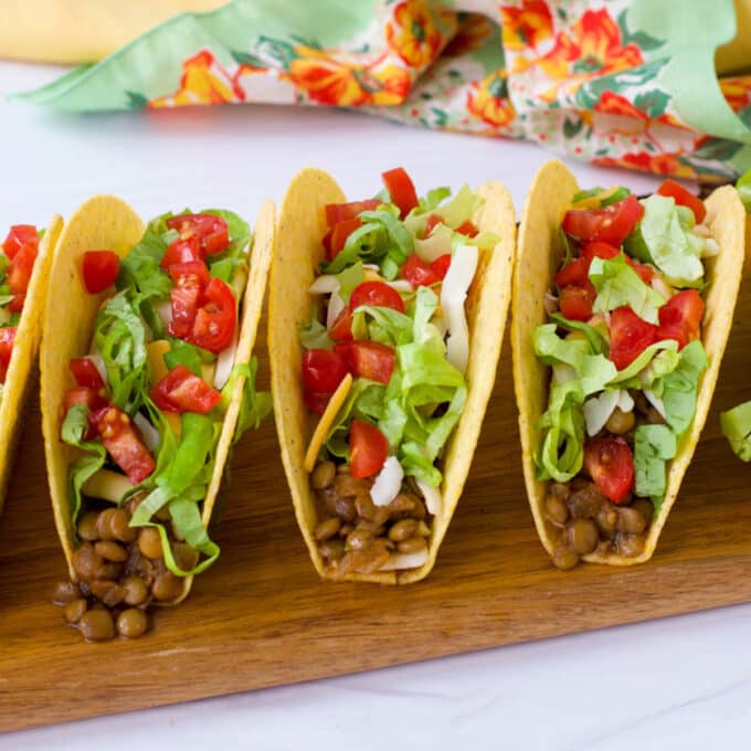 Lentils, cheese, lettuce, and tomato in hard taco shells.