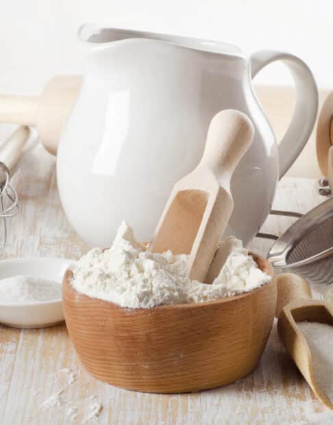 baking ingredients in white and wooden containers