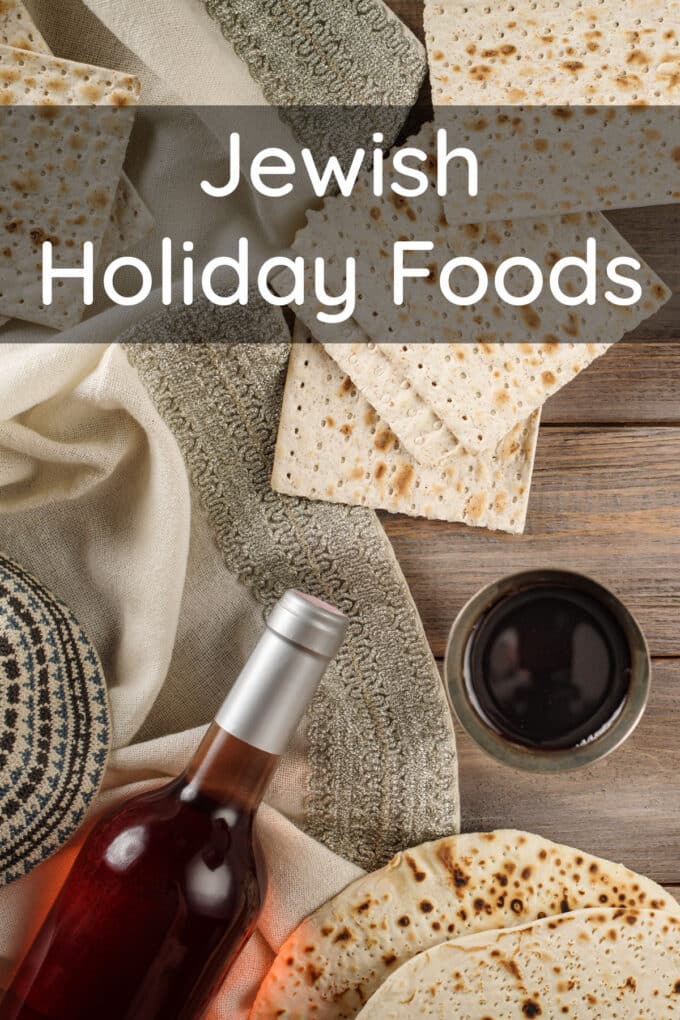 Wine and matza on a wooden table, text reads Jewish Holiday Foods.