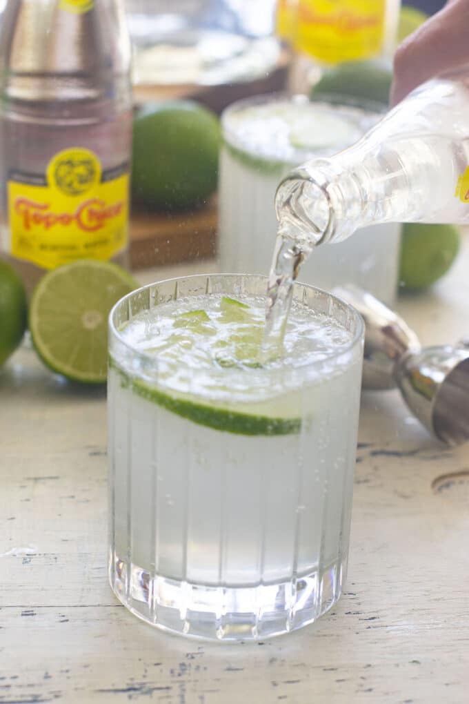 Topo Chico being poured into glass for Ranch Water cocktail.