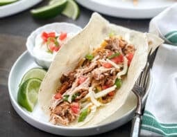 Soft shell tacos with shredded chicken filling.