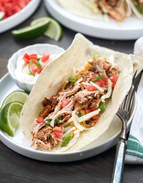Soft shell tacos with shredded chicken filling.