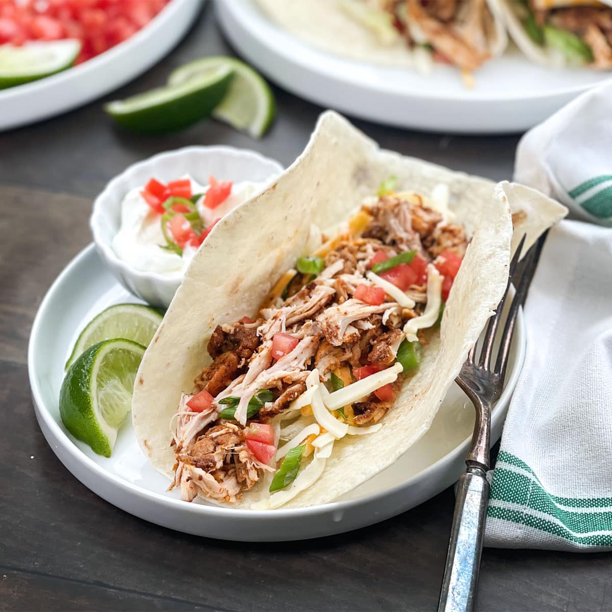 Soft shell tacos with shredded chicken filling.