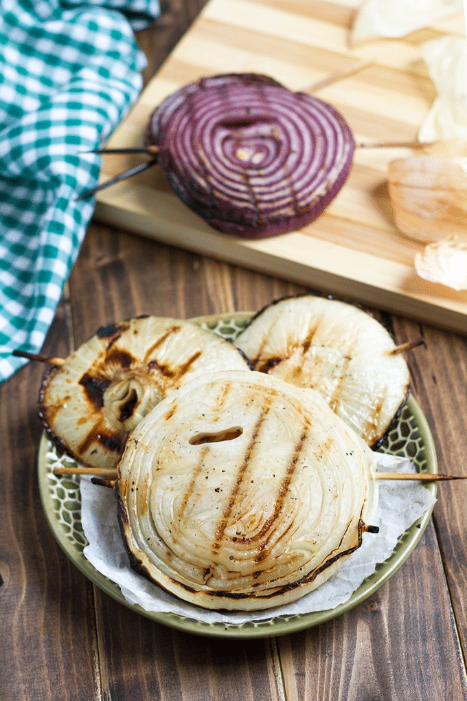 Skewered slices of grilled onion on a plate.
