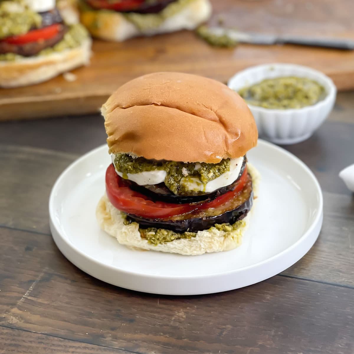 Mediterranean Eggplant Burger with tomato, mozzarella, and pesto.