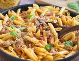 Skillet of ground turkey pasta with creamy tomato sauce.