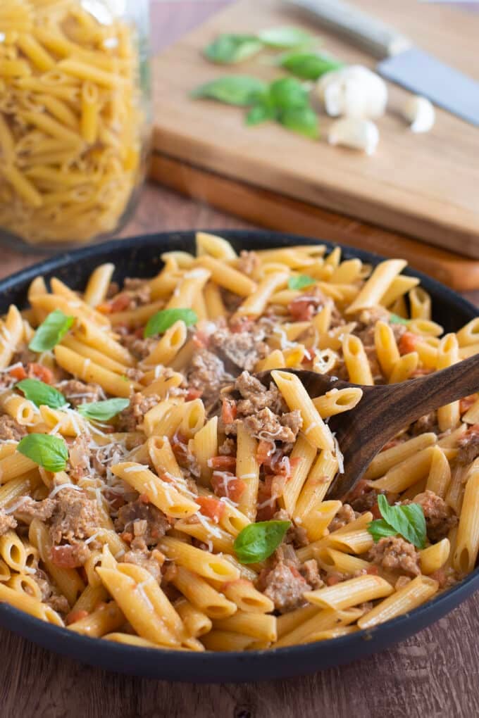 Skillet of ground turkey pasta with creamy tomato sauce.