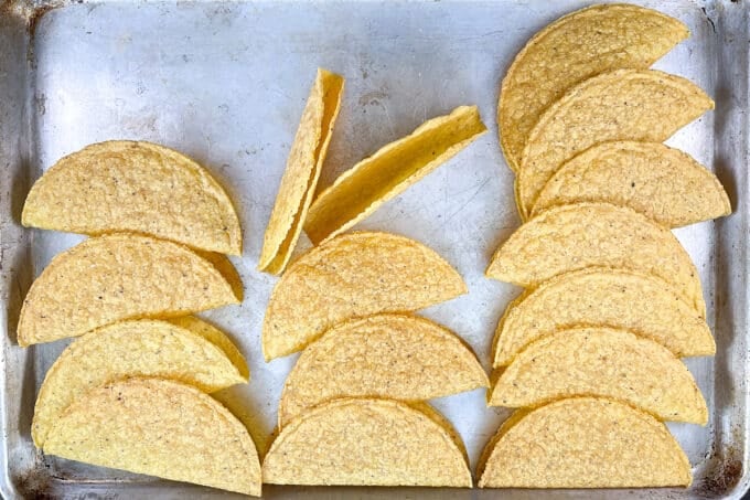 Hard taco shells on a sheet pan.