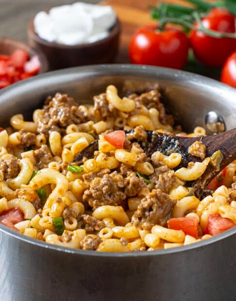 Pot of macaroni with ground beef, tomatoes, and cheese.