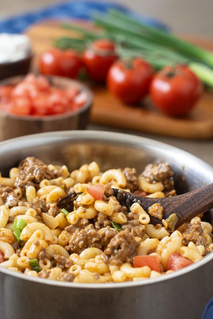 Pot of macaroni with ground beef, tomatoes, and cheese.