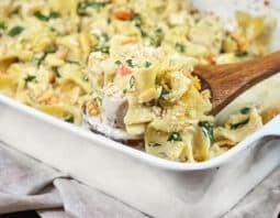 White casserole dish of chicken and noodles.