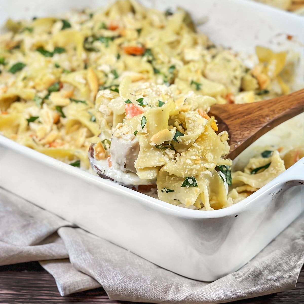 White casserole dish of chicken and noodles.