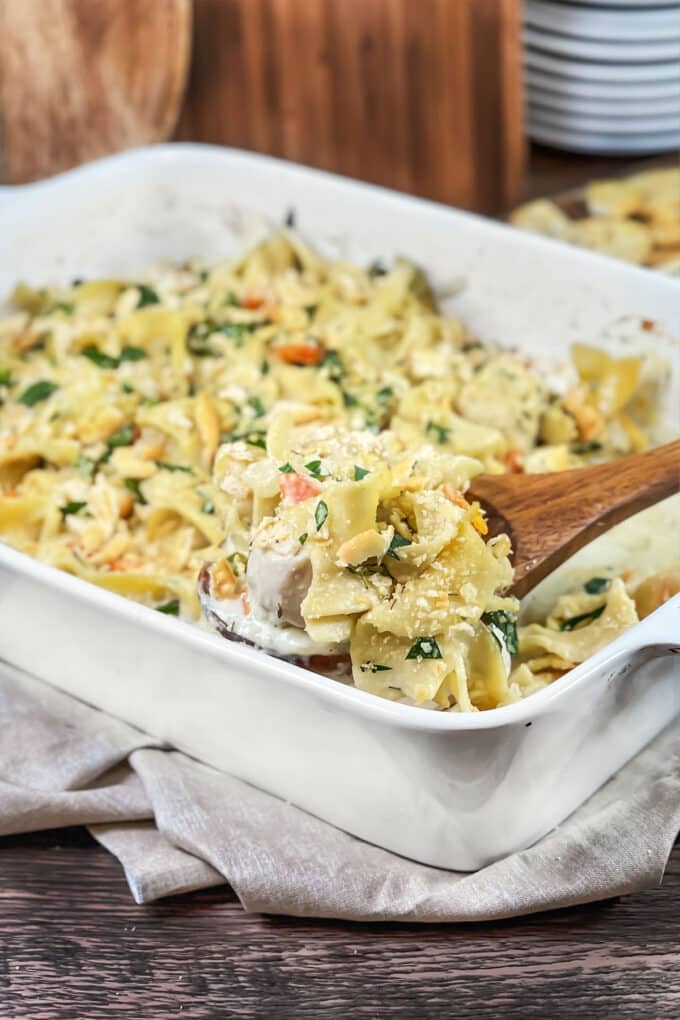 White casserole dish of chicken and noodles.