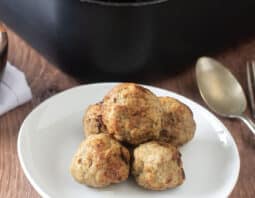 Turkey meatballs on a white plate in front of air fryer.