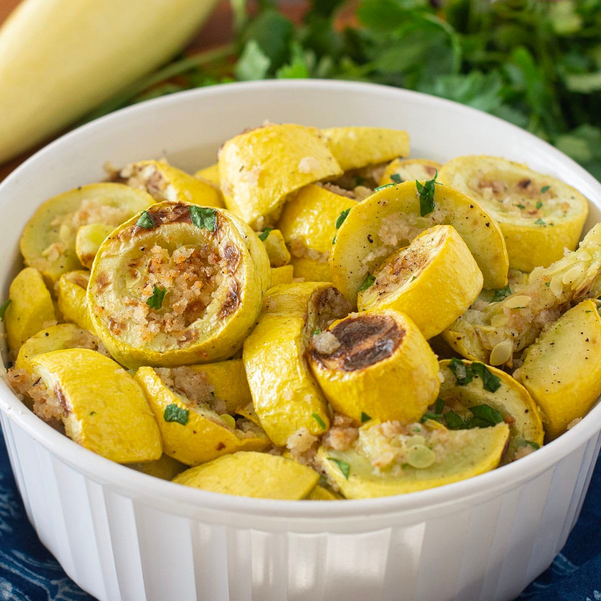 White dish of roasted yellow squash slices.