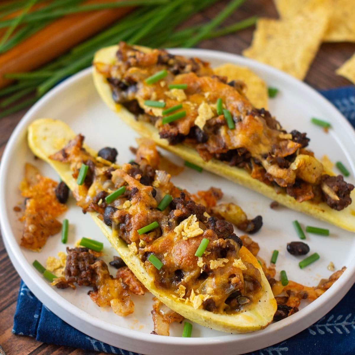 Yellow squash halves stuffed with ground beef taco mixture and topped with cheese.