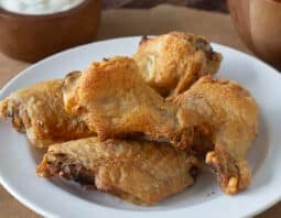 White plate of crispy baked chicken wings.