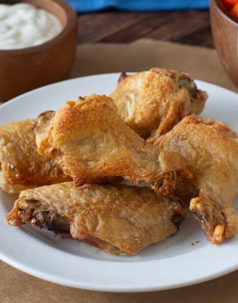 White plate of crispy baked chicken wings.