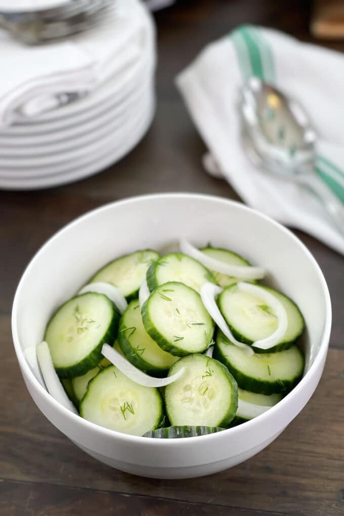 White bowl of cucumber onion salad.