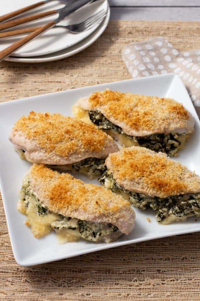 Four chicken breasts stuffed with spinach and cheese and topped with breadcrumbs.