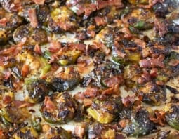 Crispy smashed Brussels sprouts with bacon on a baking sheet.