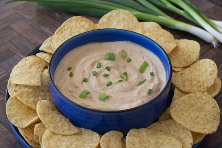 Cottage Cheese Queso Dip in a bowl surrounded by tortilla chips