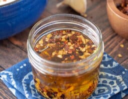 Glass jar with homemade garlic chili oil.