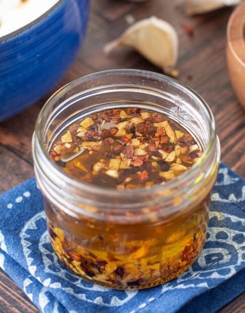 Glass jar with homemade garlic chili oil.