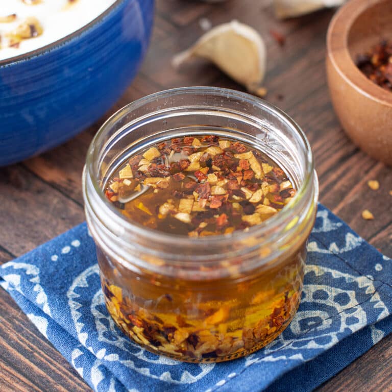 Glass jar with homemade garlic chili oil.