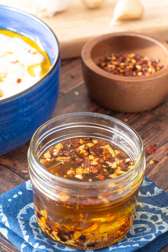 Glass jar with homemade garlic chili oil.