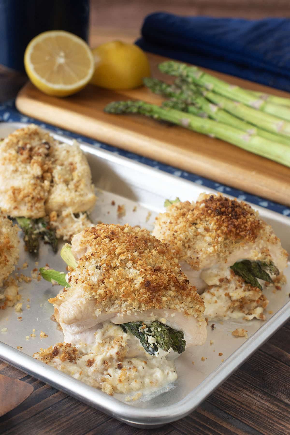 Whit platter with 4 asparagus stuffed chicken breasts with breadcrumb topping.