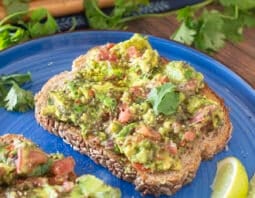 Avocado toast with tomatoes and cilantro.