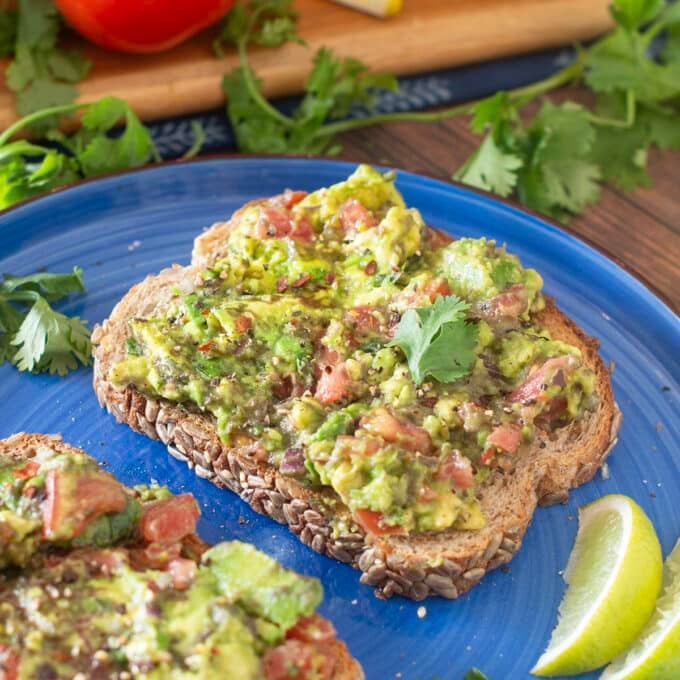 Avocado toast with tomatoes and cilantro.