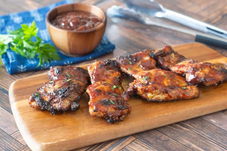 Grilled BBQ Chicken Thighs on a cutting board
