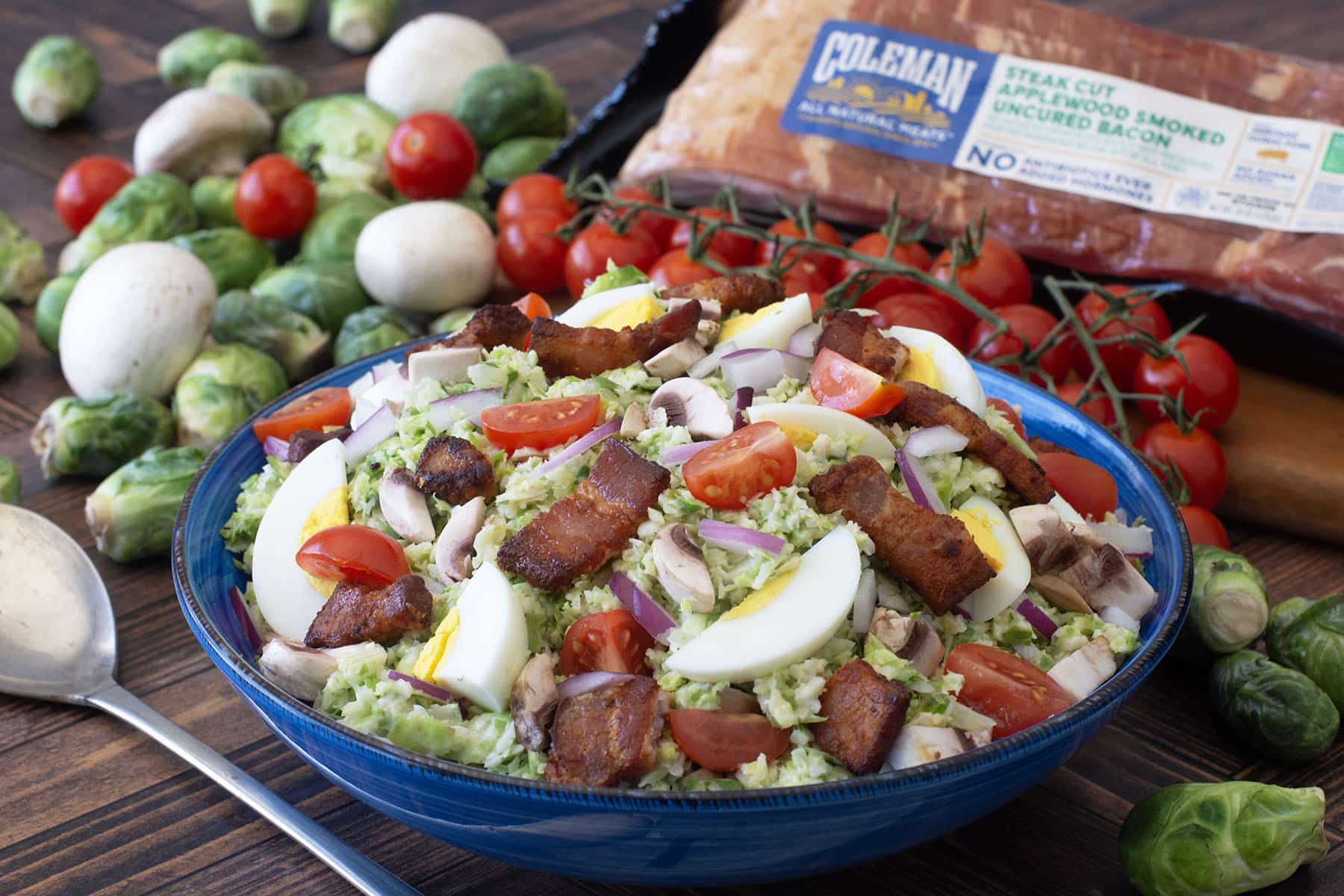 Shredded Brussels sprouts with bacon, hard boiled eggs, and tomatoes.