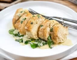 Sliced chicken florentine on a white plate.