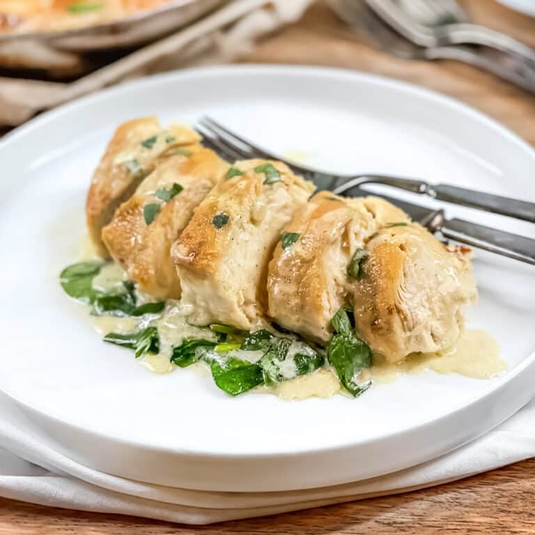 Sliced chicken florentine on a white plate.